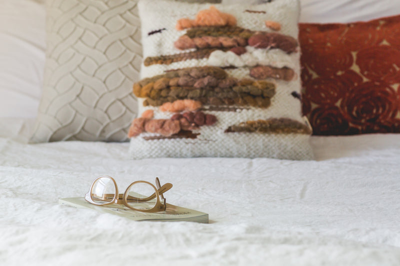 Hantique pillows styled on a bed